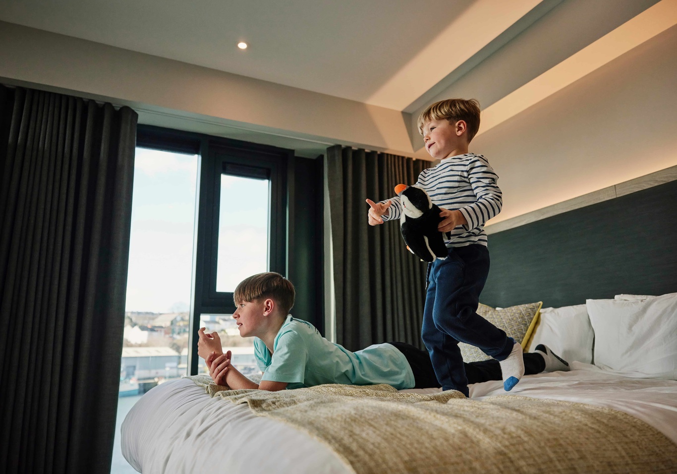 Children jumping on the bed