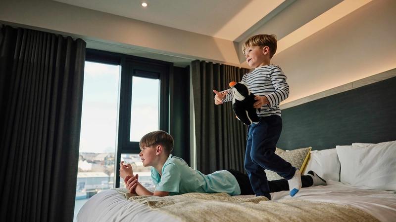 Children jumping on the bed