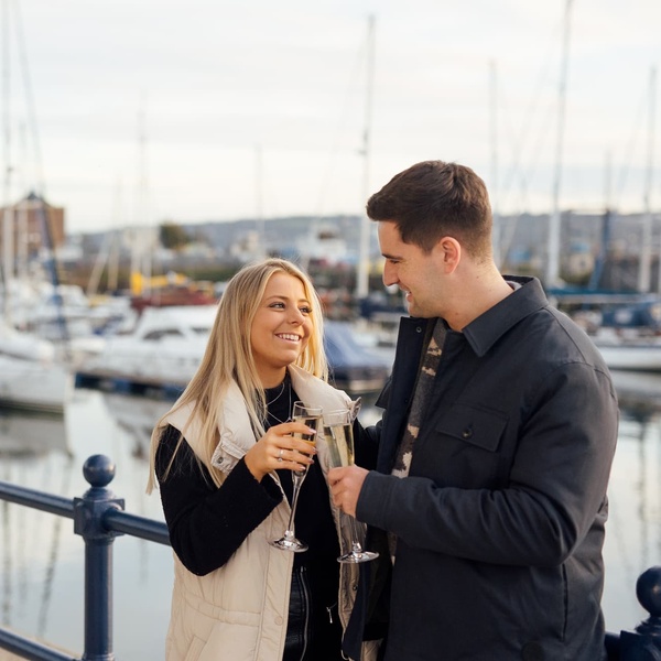 Couple on the Waterfront with Champagne