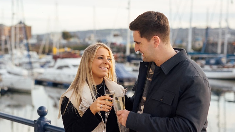 Couple on the Waterfront with Champagne
