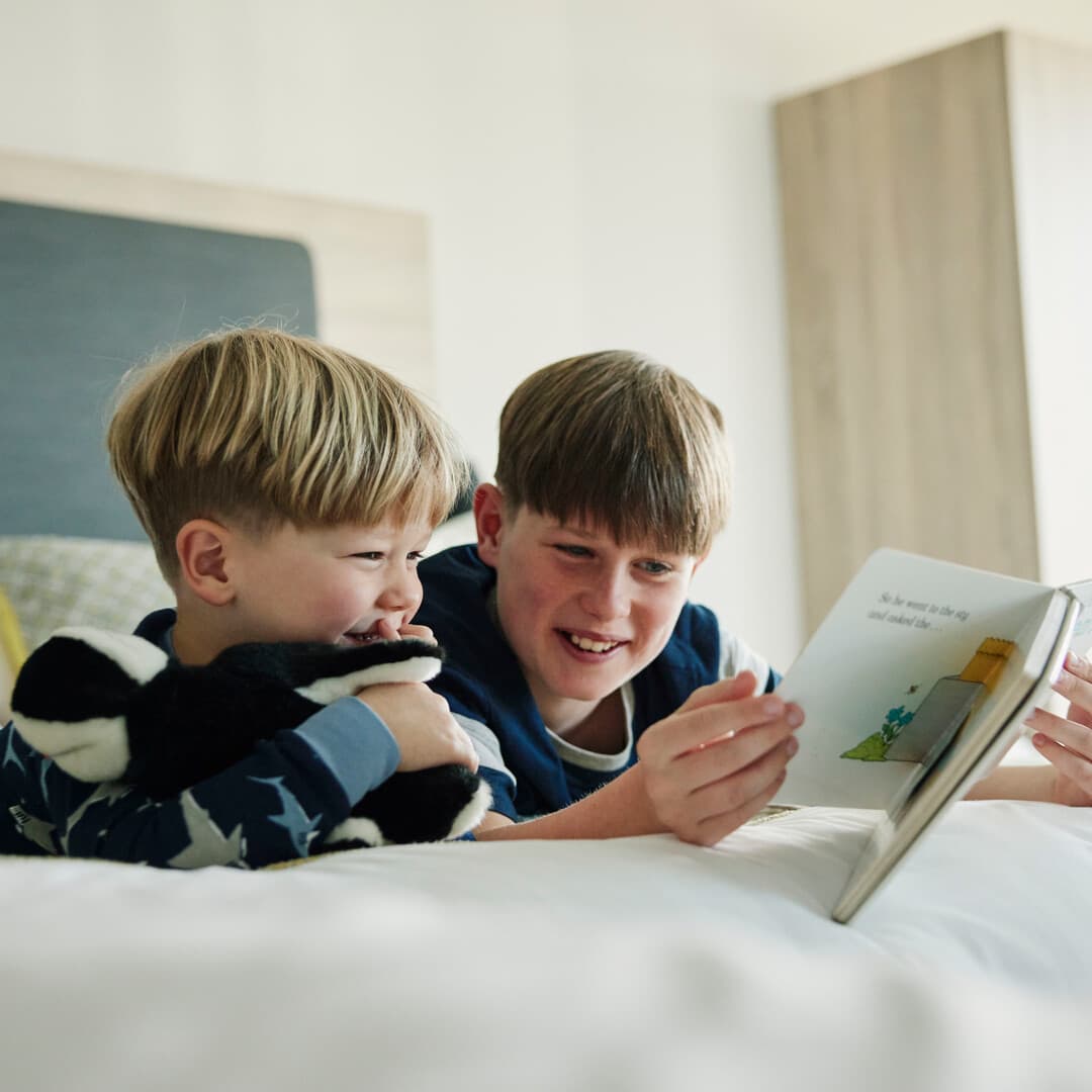 Children Reading in Family Bedroom