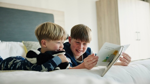 Children Reading in Family Bedroom
