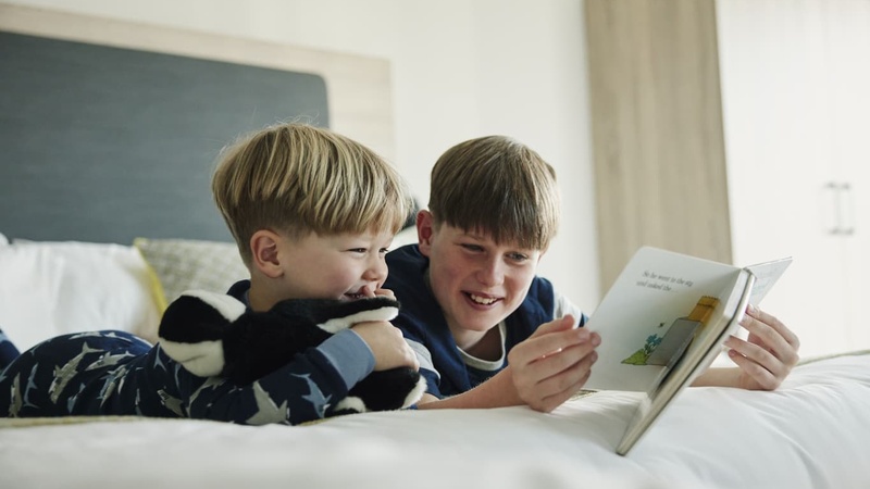 Children Reading in Family Bedroom